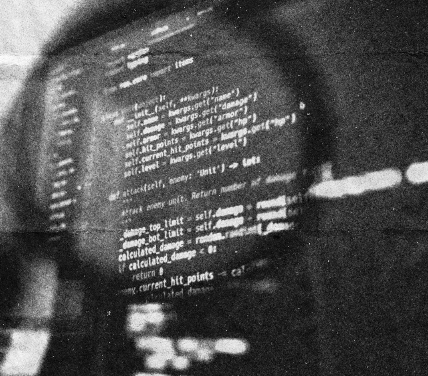 A magnifying glass held over lines of code on a screen