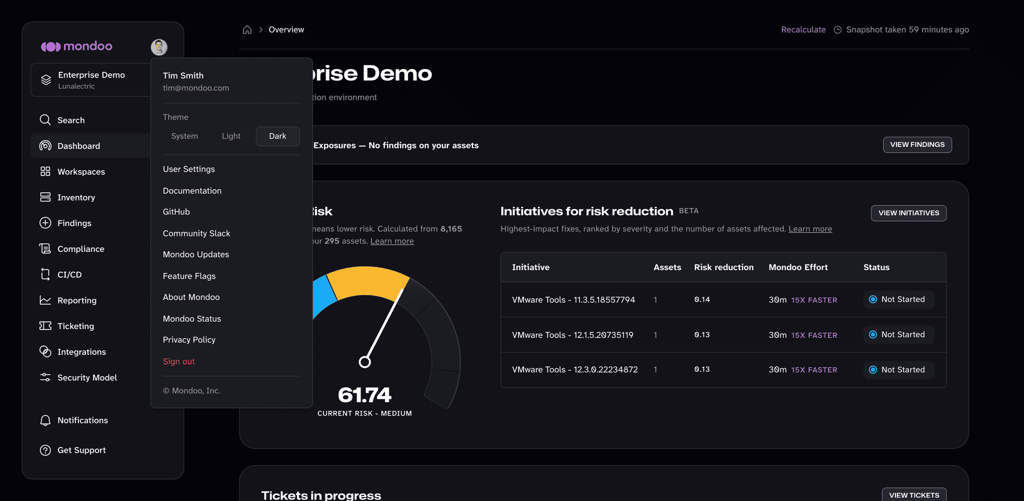 The account menu open, showing the theme options and links such as User Settings, Documentation, Feature Flags, and Mondoo Status